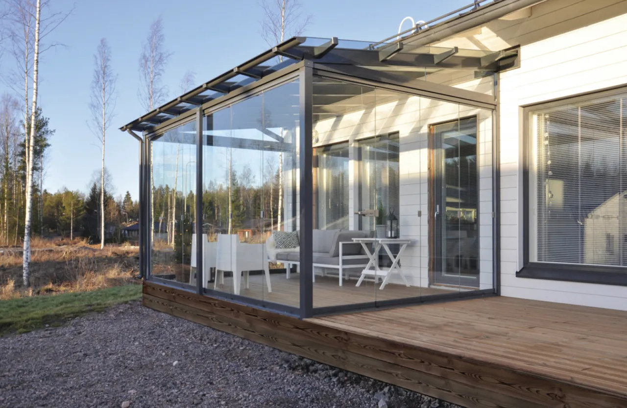 A four-season glass enclosure in Palmer Lake, CO, constructed with thermally broken aluminum framing and reinforced glass roof panels rated for 75 PSF Front Range snow loads.